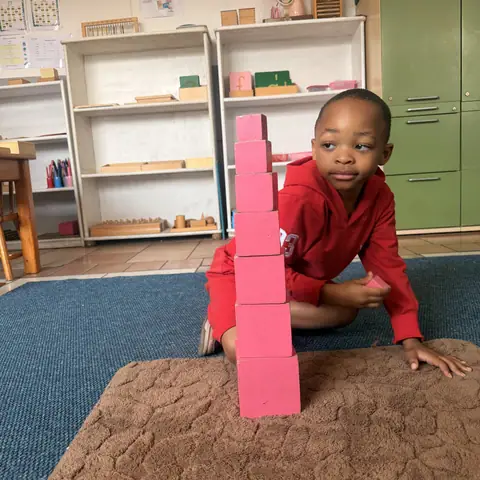 Building the pink tower in kindergarten