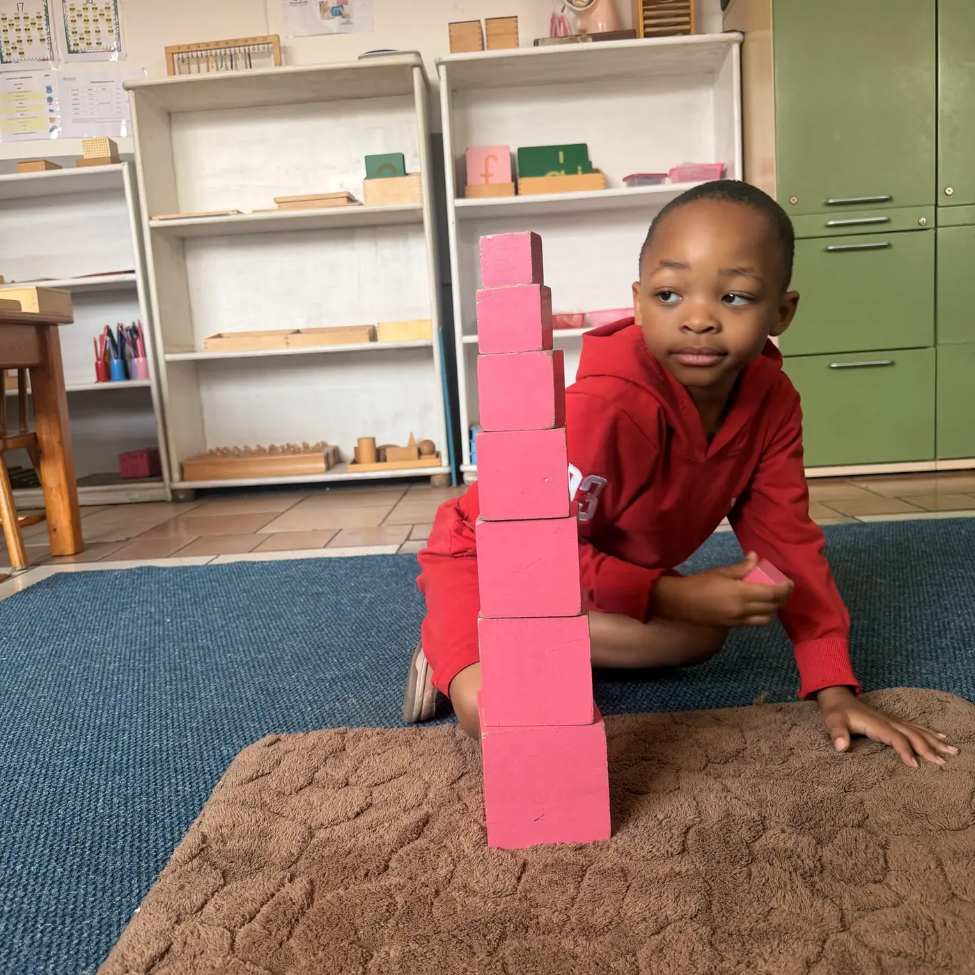 Building the pink tower in kindergarten